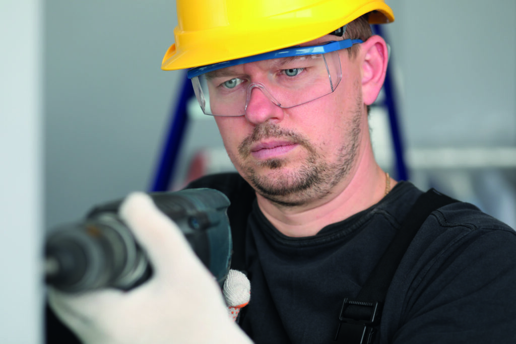 Ein Mann arbeitet mit einer Bohrmaschine.